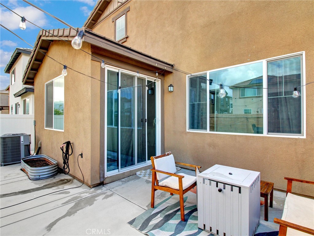 2497 Gunner Ridge Way Rialto, CA 92377 - Photo 38 of 49 a view of a patio with a table and chairs and potted plants