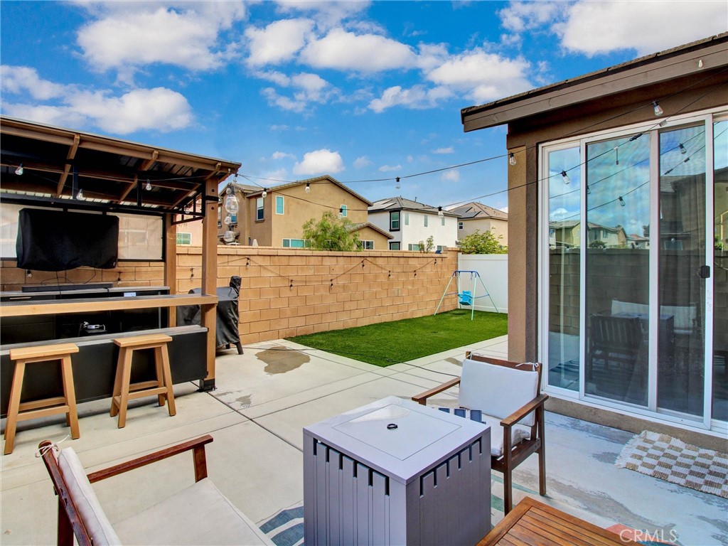 2497 Gunner Ridge Way Rialto, CA 92377 - Photo 39 of 49 a view of a kitchen with a table and chairs in front of it