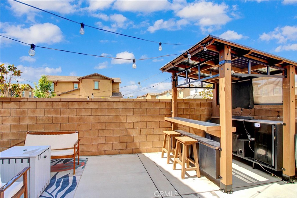 2497 Gunner Ridge Way Rialto, CA 92377 - Photo 42 of 49 a patio with table and chairs