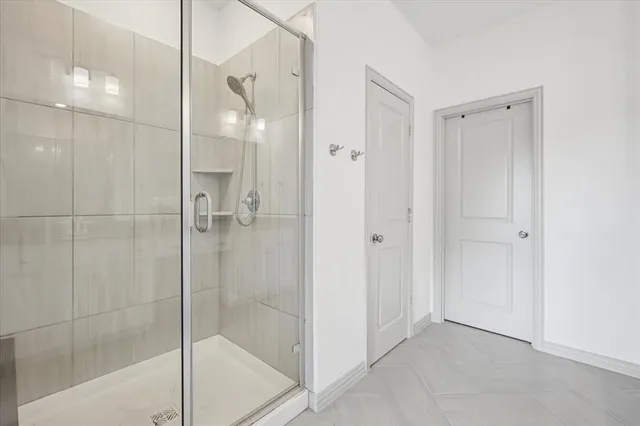 a bathroom with a glass shower door and a sink
