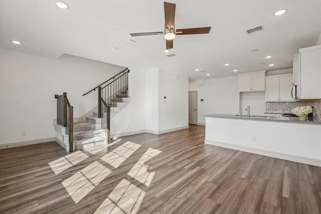 a view of kitchen and hall with wooden floor