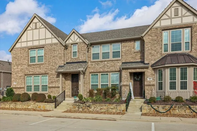 a front view of a house with a yard and outdoor seating