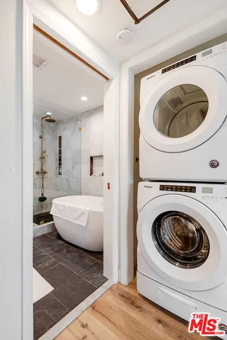 a living room with a couch and a washer dryer