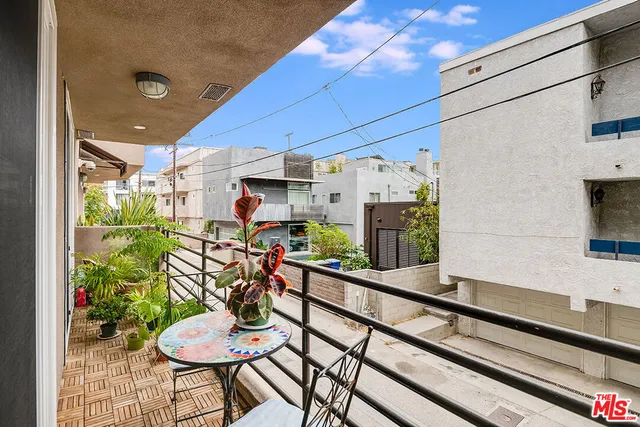 a room with lots of wooden furniture and a potted plant