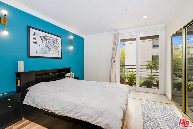 a bedroom with a large bed and a large window