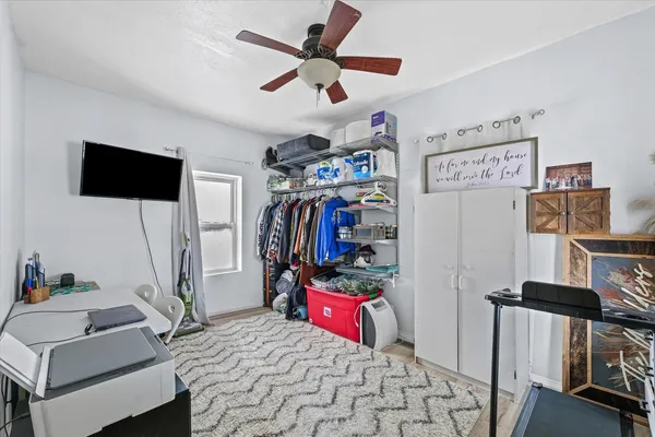 a view of a workspace with furniture and a flat screen tv