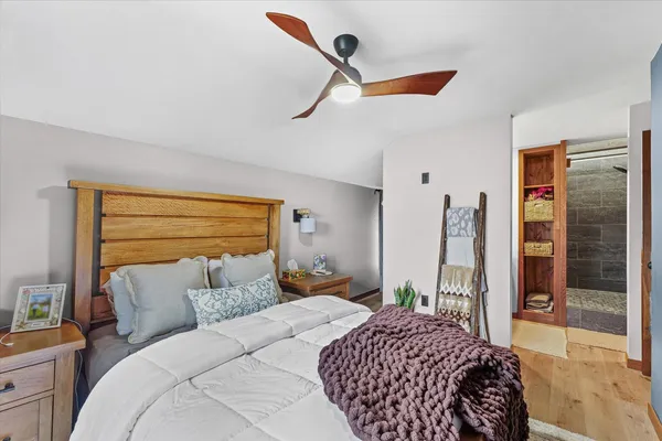 a bedroom with a bed and a large window