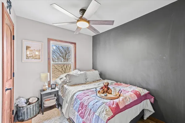 a bedroom with a bed and a chandelier