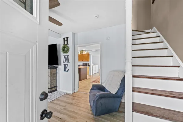 a view of entryway and hall with wooden floor