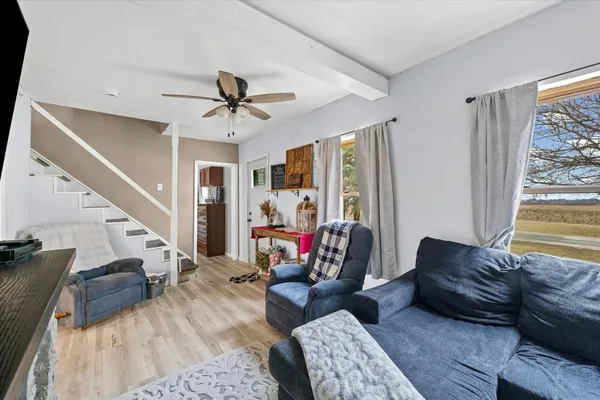 a living room with furniture and a chandelier