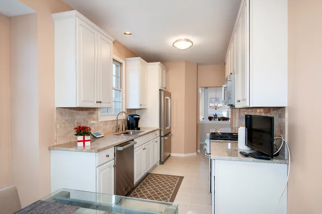 a kitchen with stainless steel appliances a refrigerator sink and cabinets