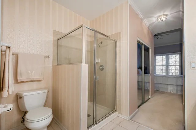 a bathroom with a shower a toilet and a sink