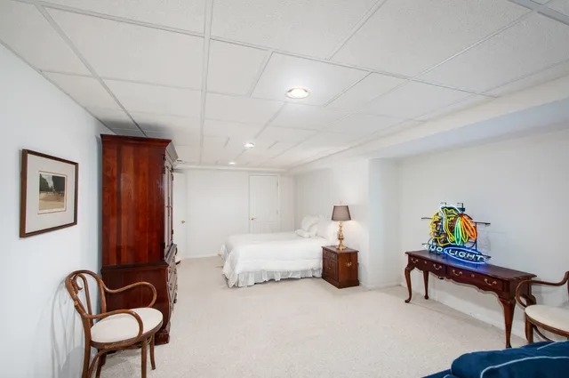 a bedroom with furniture and a chair