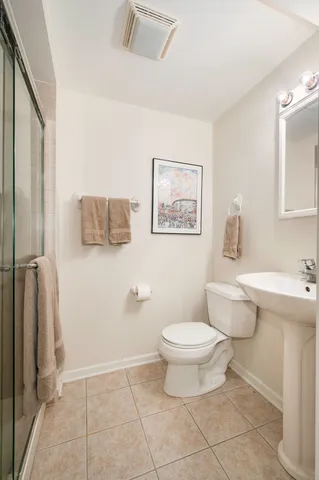 a bathroom with a toilet sink and a mirror