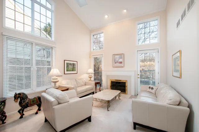 a living room with furniture fireplace and a window