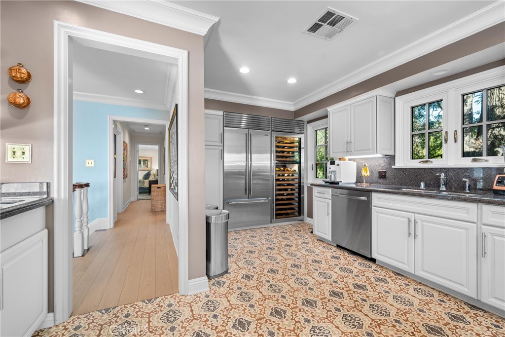 913 Sherlock Drive Burbank, CA 91501 - Photo 23 of 53 a kitchen with stainless steel appliances kitchen island granite countertop a refrigerator and cabinets