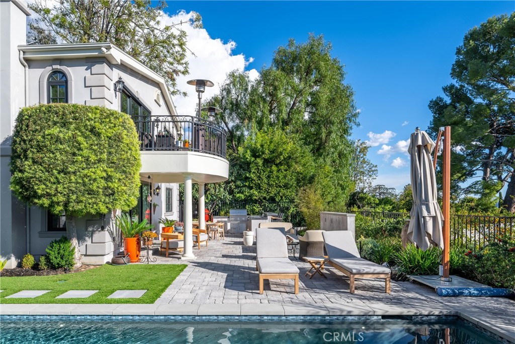 913 Sherlock Drive Burbank, CA 91501 - Photo 33 of 53 a view of a patio with table and chairs potted plants and palm tree