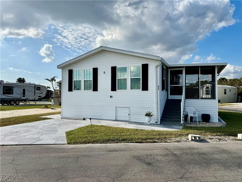 19681 Summerlin Road, Unit 217 Fort Myers, FL 33908 - Photo 1 of 24 a view of a house with yard and sitting area