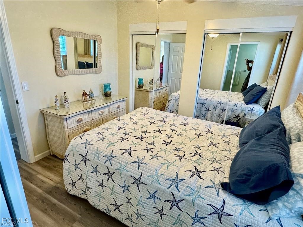 19681 Summerlin Road, Unit 217 Fort Myers, FL 33908 - Photo 11 of 24 a bedroom with a bed and a mirror