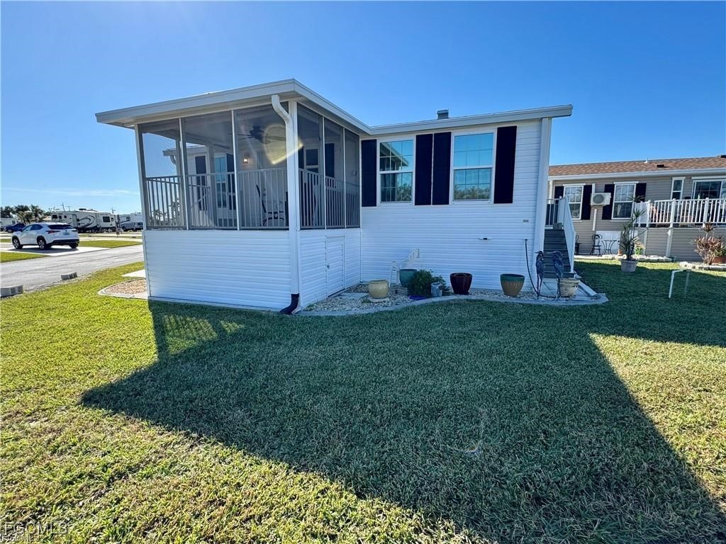 19681 Summerlin Road, Unit 217 Fort Myers, FL 33908 - Photo 20 of 24 a front view of a house with garden