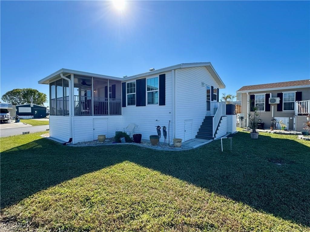 19681 Summerlin Road, Unit 217 Fort Myers, FL 33908 - Photo 21 of 24 a front view of a house with a garden and yard