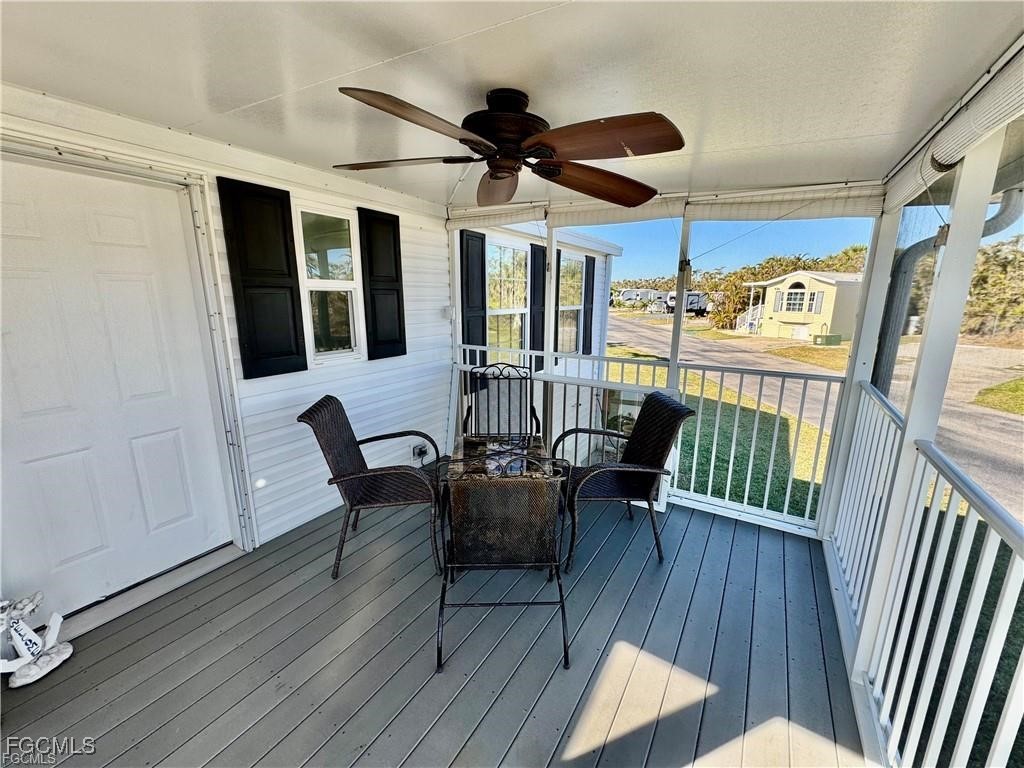 19681 Summerlin Road, Unit 217 Fort Myers, FL 33908 - Photo 3 of 24 a dining room with wooden floor a chandelier a glass table and chairs