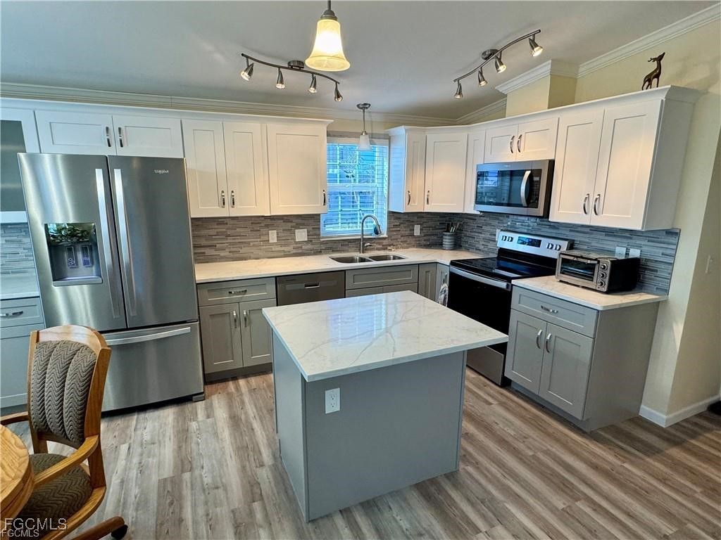 19681 Summerlin Road, Unit 217 Fort Myers, FL 33908 - Photo 8 of 24 a kitchen with stainless steel appliances a refrigerator stove microwave and sink