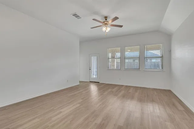 wooden floor in an empty room with a window