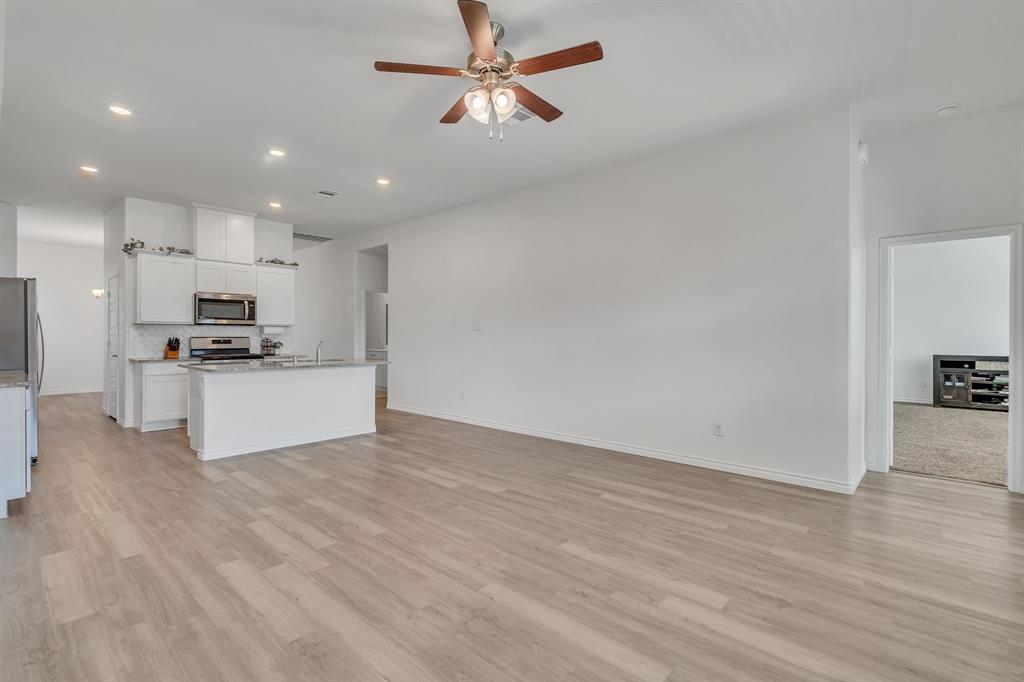 1009 Azure Lane Celina, TX 75009 - Photo 13 of 20 a view of kitchen with granite countertop cabinets and refrigerator