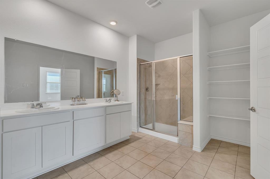 1009 Azure Lane Celina, TX 75009 - Photo 16 of 20 a bathroom with a double vanity sink and mirror