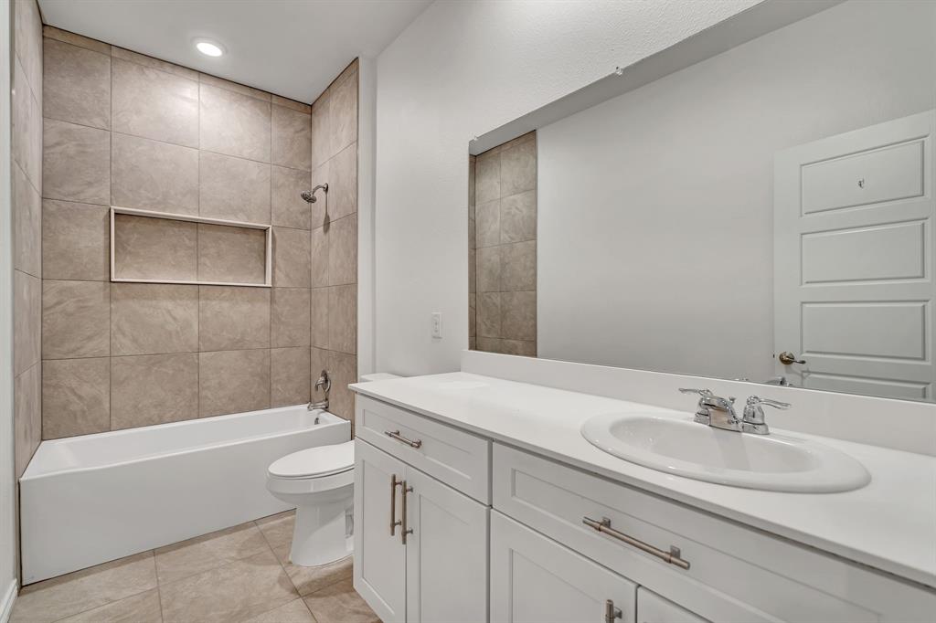 1009 Azure Lane Celina, TX 75009 - Photo 18 of 20 a bathroom with a sink a toilet and bathtub