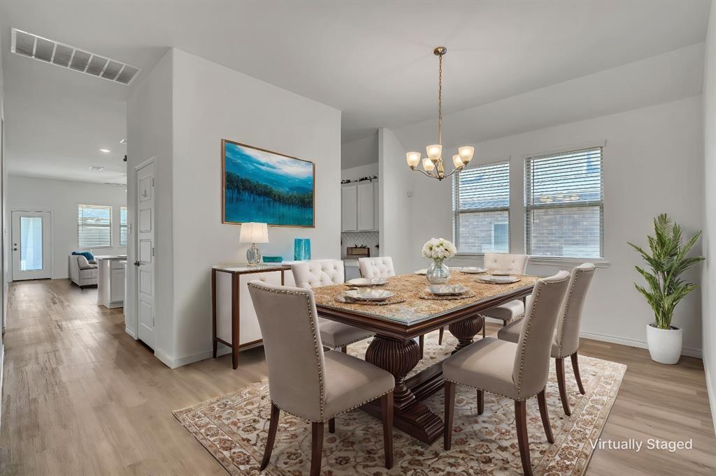 1009 Azure Lane Celina, TX 75009 - Photo 2 of 20 a view of a dining room with furniture window and wooden floor
