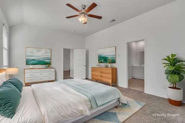 a bedroom with a bed and a potted plant