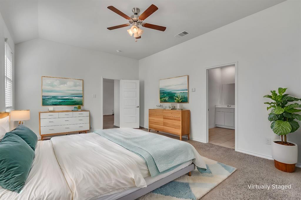 1009 Azure Lane Celina, TX 75009 - Photo 4 of 20 a bedroom with a bed and a potted plant