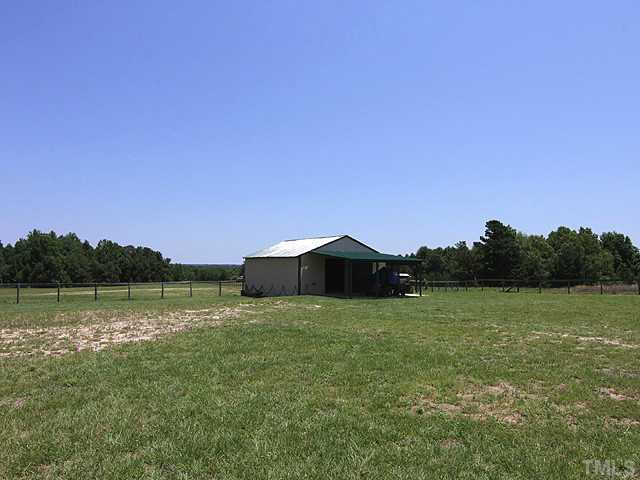 1948 Johnston County Road Benson, NC 27504 - Photo 11 of 13 a view of a field with a lake in the background
