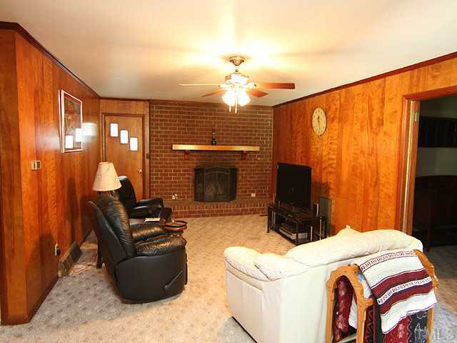 1948 Johnston County Road Benson, NC 27504 - Photo 2 of 13 a bedroom with furniture and a fireplace