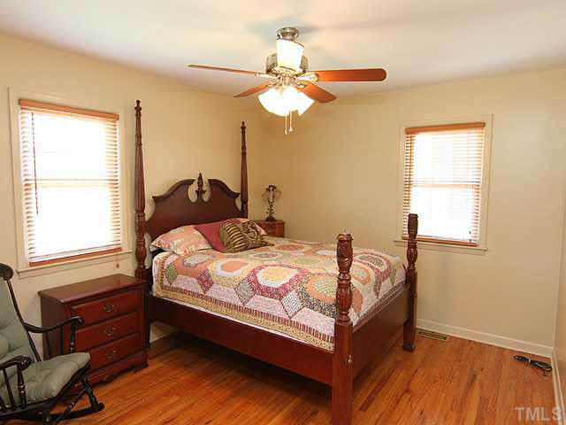 1948 Johnston County Road Benson, NC 27504 - Photo 6 of 13 a bed sitting in a bedroom next to a window