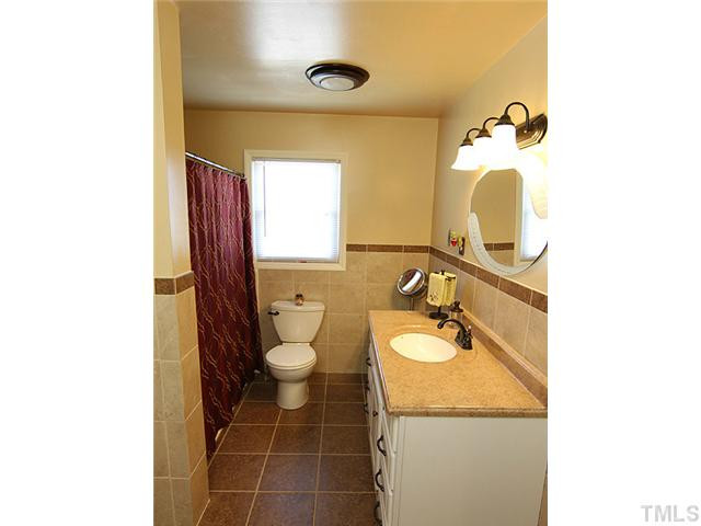 1948 Johnston County Road Benson, NC 27504 - Photo 7 of 13 a bathroom with a granite countertop sink and a mirror
