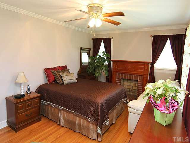 1948 Johnston County Road Benson, NC 27504 - Photo 8 of 13 a bedroom with bed and a chandelier