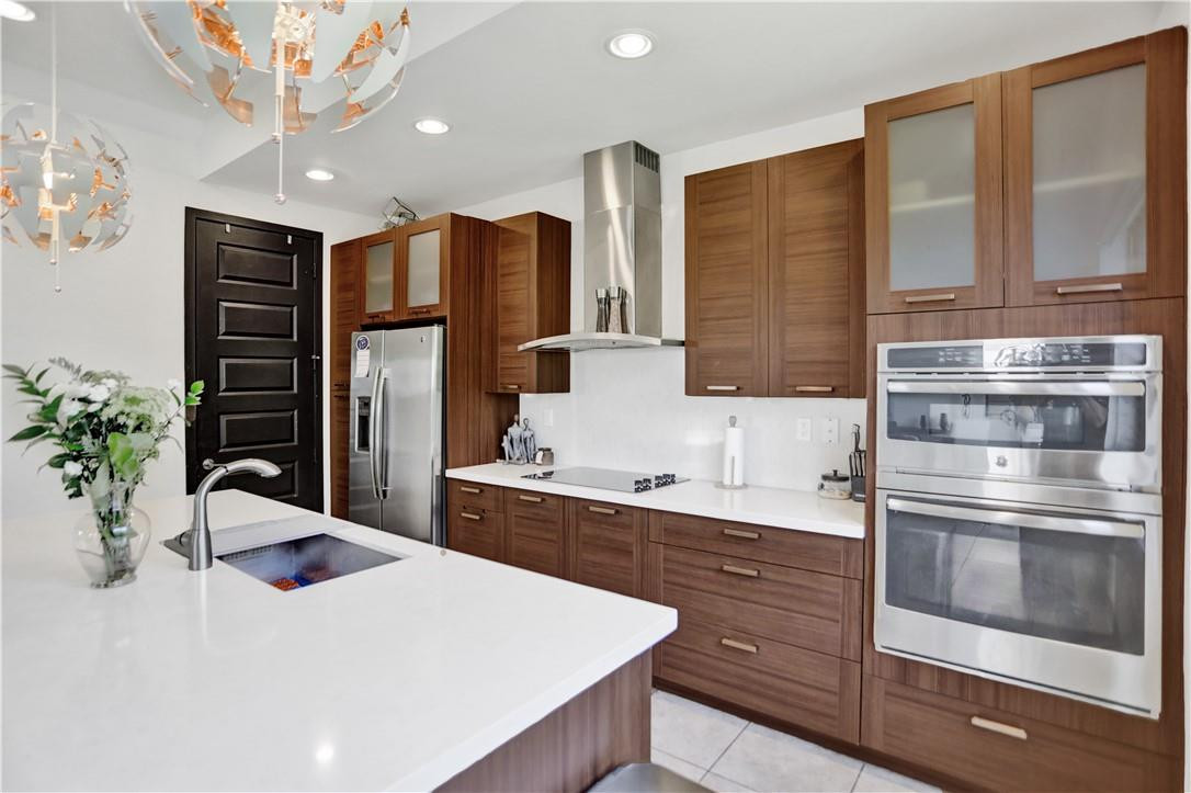 16001 Southwest 136 Way Miami, FL 33196 - Photo 19 of 66 a kitchen with stainless steel appliances kitchen island granite countertop a refrigerator a sink and dishwasher