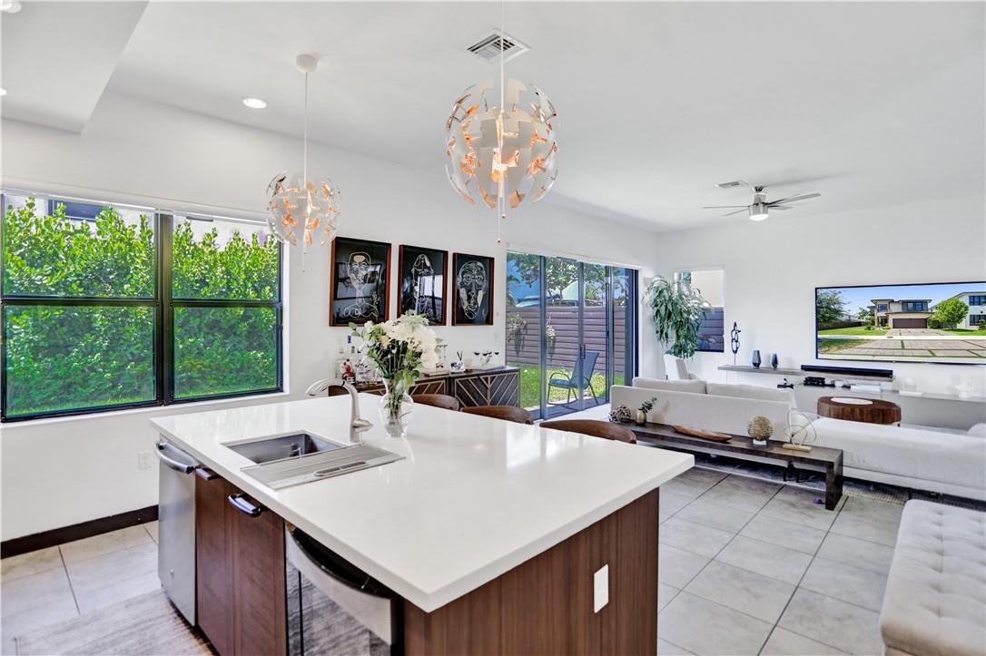 16001 Southwest 136 Way Miami, FL 33196 - Photo 22 of 66 a view of a dining room with furniture a chandelier and large windows