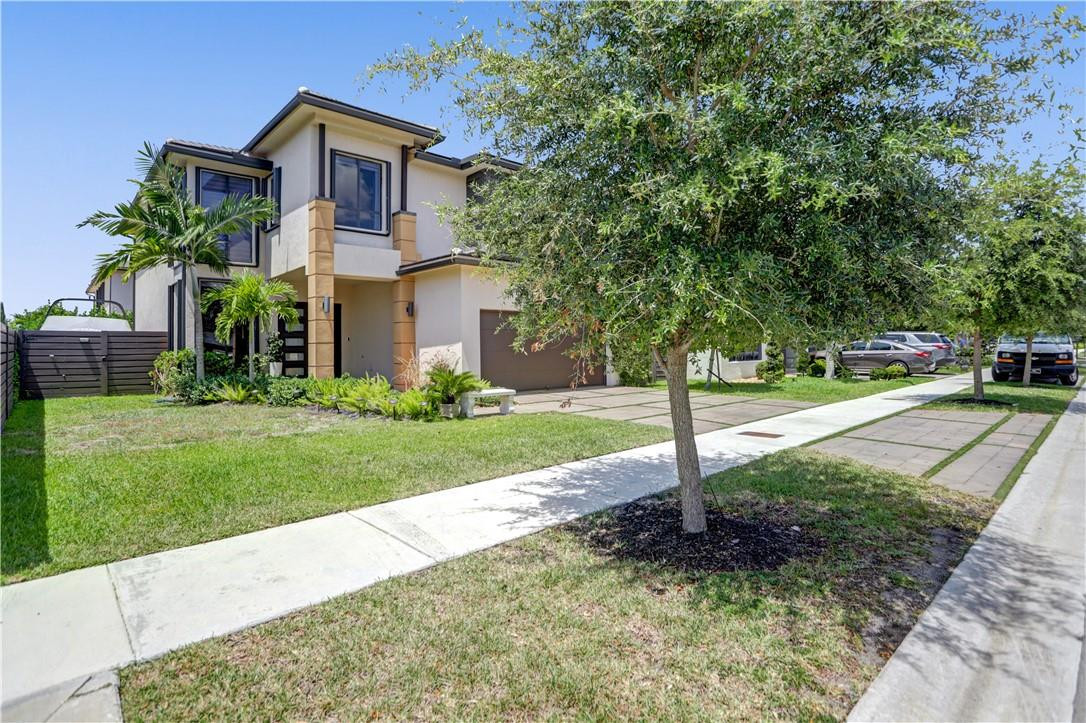 16001 Southwest 136 Way Miami, FL 33196 - Photo 3 of 66 a front view of a house with a yard and tree