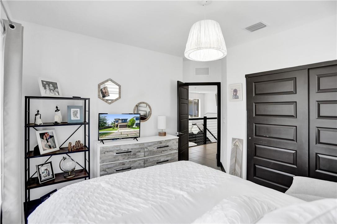 16001 Southwest 136 Way Miami, FL 33196 - Photo 51 of 66 a bedroom with a bed and a closet