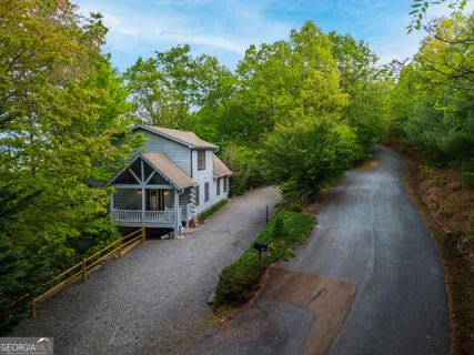 an aerial view of a house with yard and green space