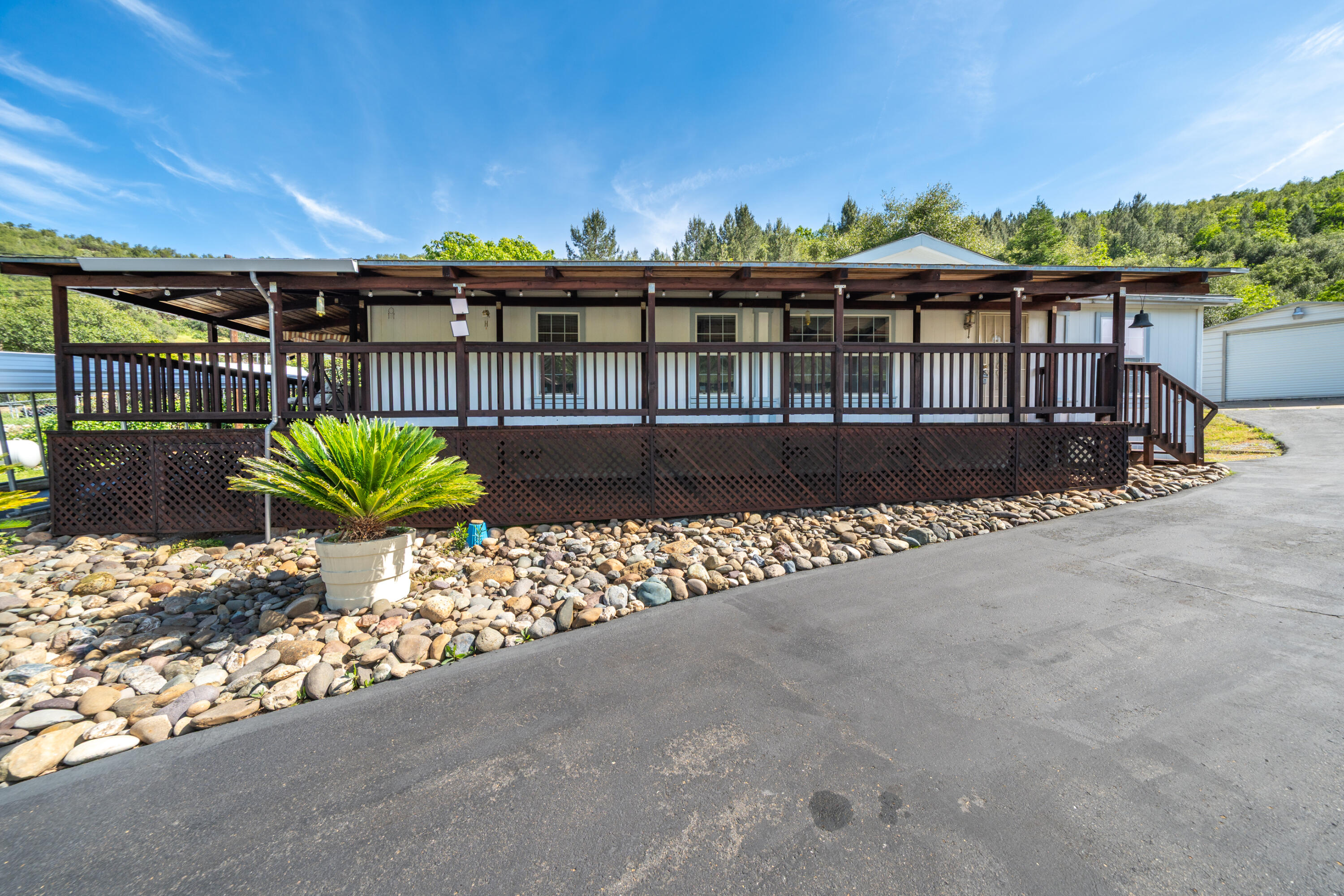 22151 Ravine Court Redding, CA 96003 - Photo 20 of 34 a view of a house with a flower in a garden