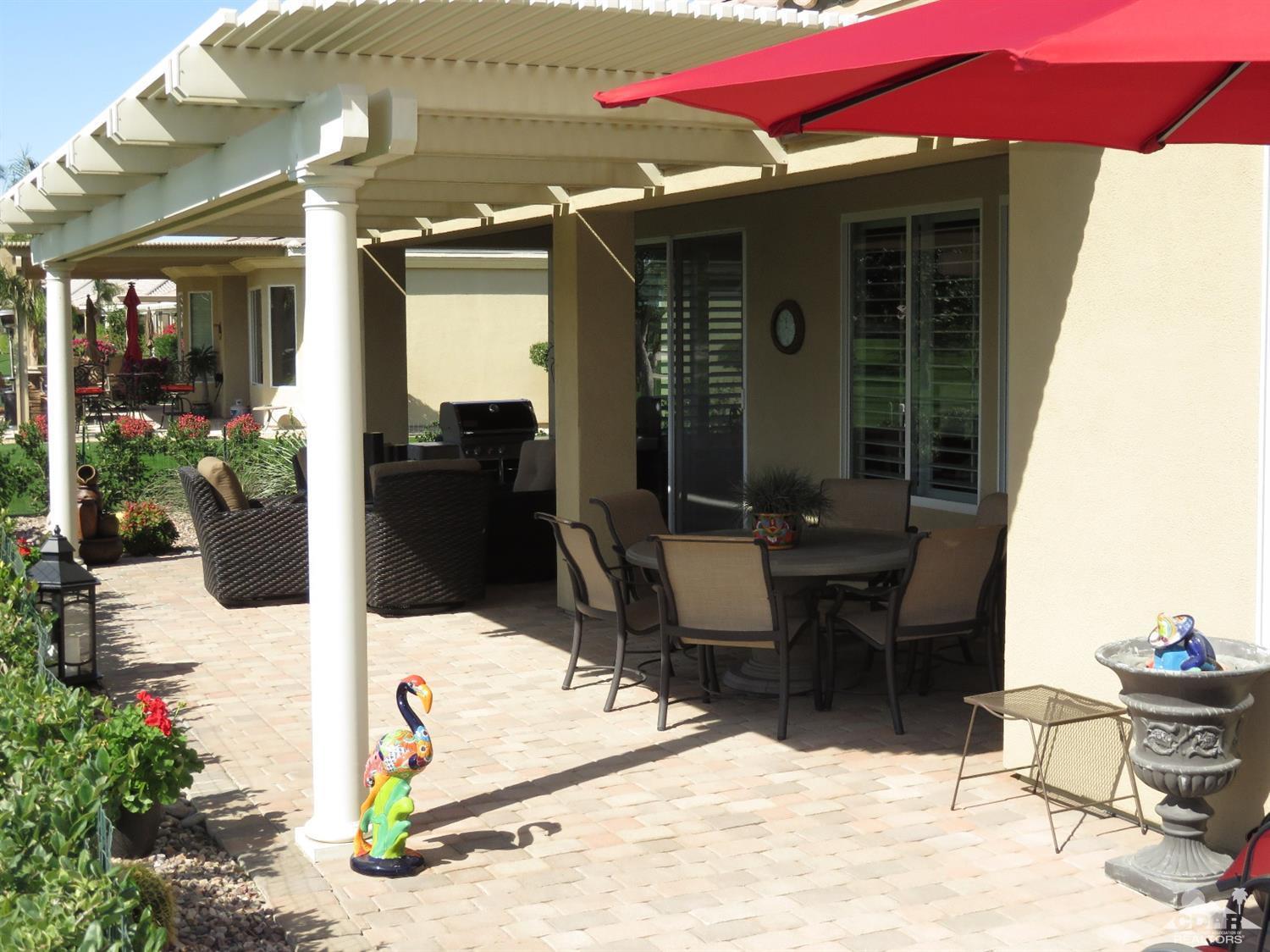 80567 Knightswood Road Indio, CA 92201 - Photo 40 of 57 a view of a patio with table and chairs potted plants