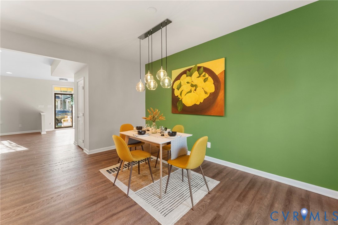 5504 Riverside Heights Way Richmond, VA 23225 - Photo 12 of 29 a view of a dining room with furniture and wooden floor