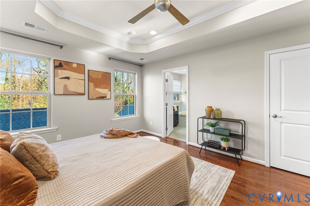 5504 Riverside Heights Way Richmond, VA 23225 - Photo 15 of 29 a bedroom with a bed a table and painting on the wall
