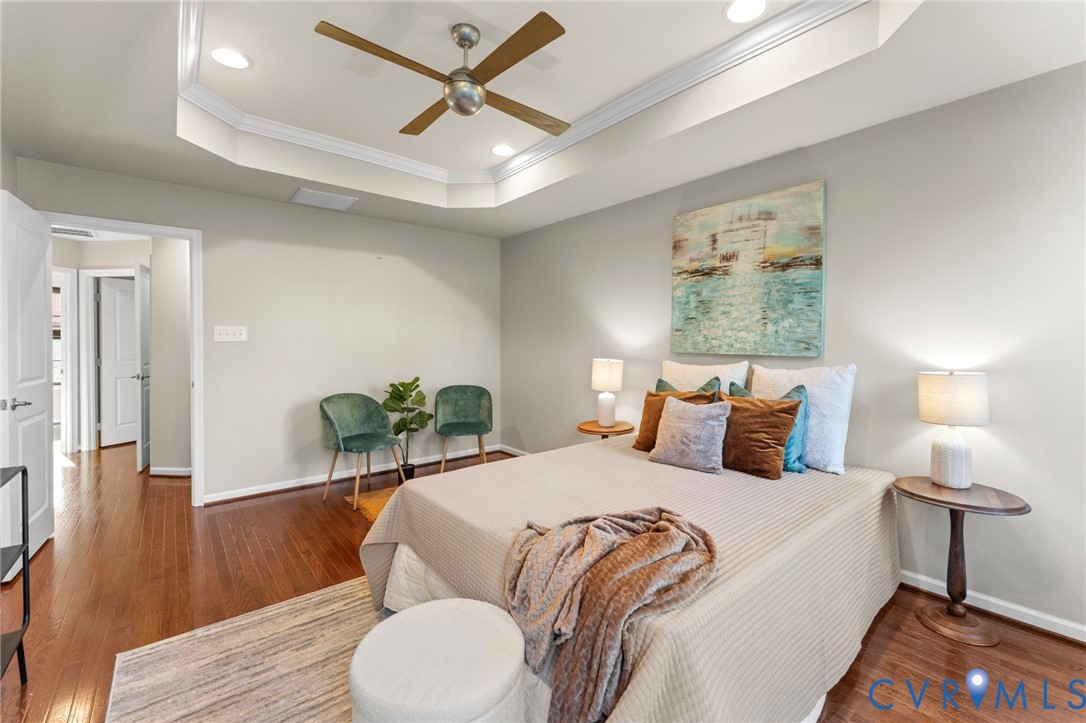 5504 Riverside Heights Way Richmond, VA 23225 - Photo 16 of 29 a bedroom with a bed and wooden floor
