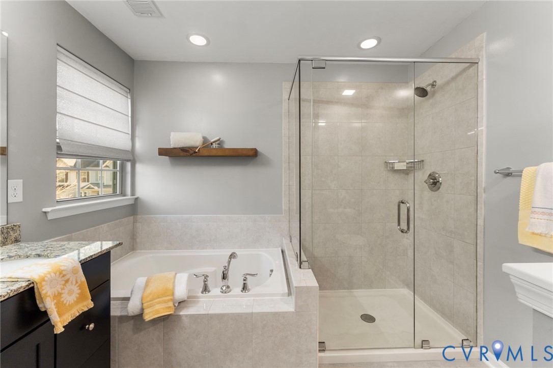 5504 Riverside Heights Way Richmond, VA 23225 - Photo 17 of 29 a bathroom with a tub shower sink and vanity